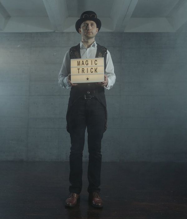 A person performing a light lunge in a modern, dark room with yellow light accents.